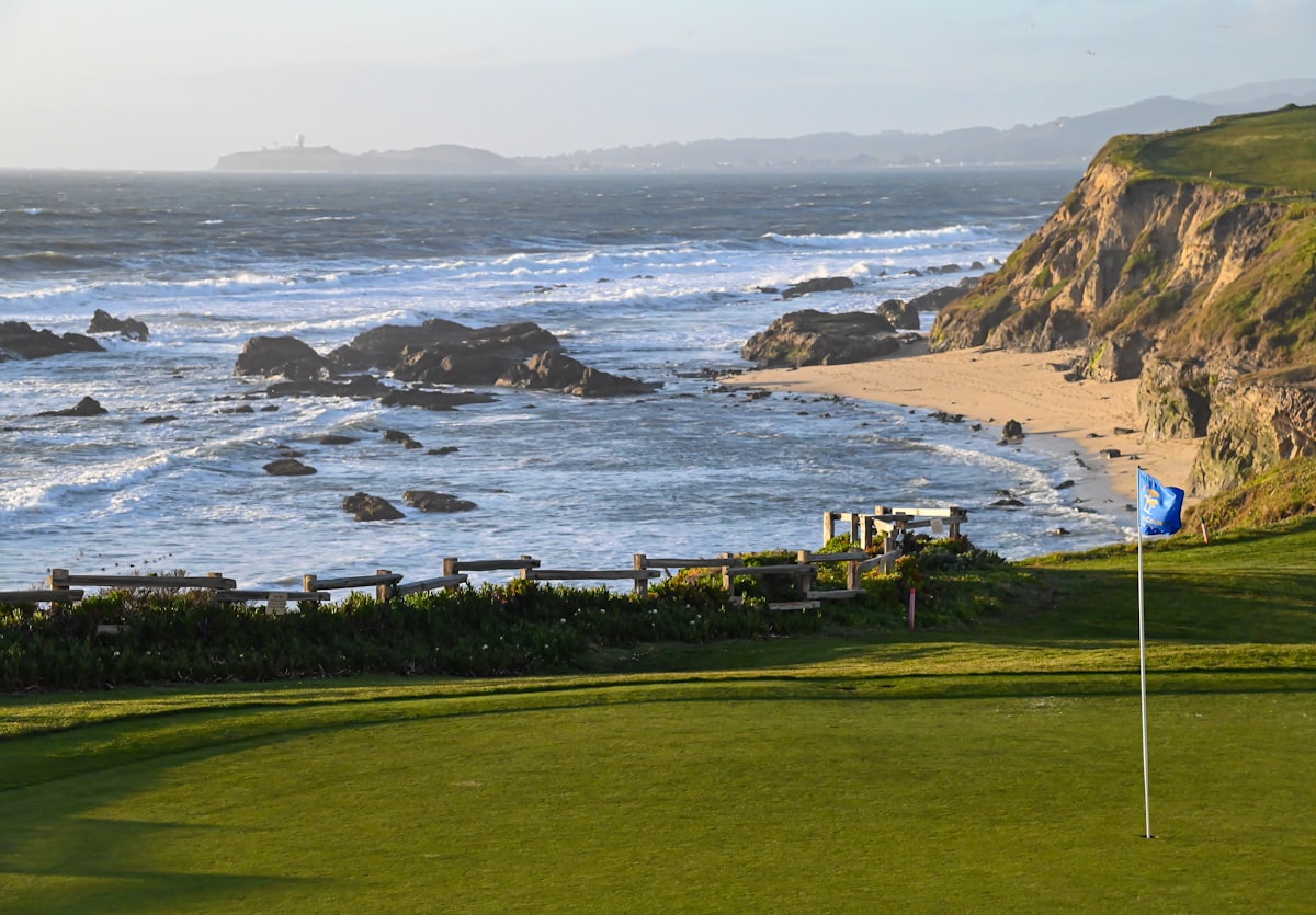 A golf green beside the ocean