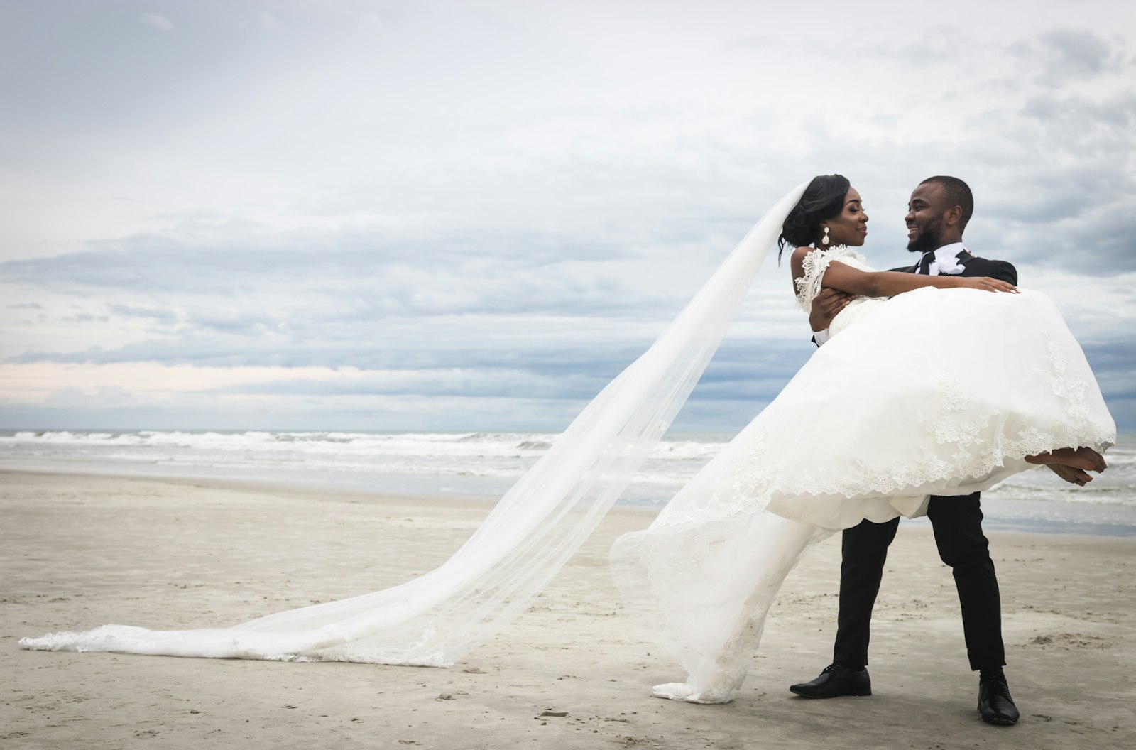 Bride and groom kissing on the beach